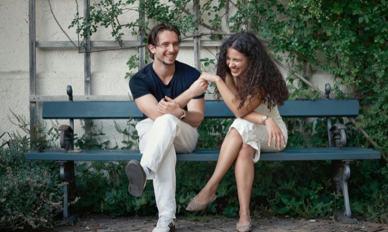 kobieta-mezczyzna-siedza-i-rozmawiaja-na-lawce-rozesmiani